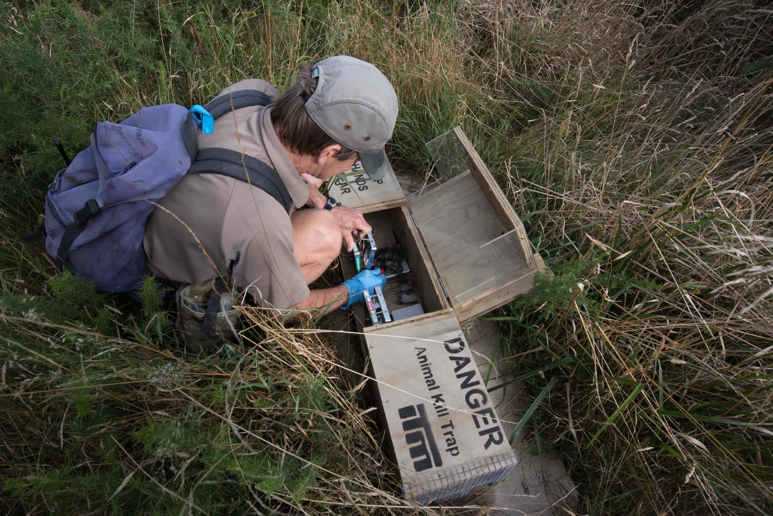 man with stoat trap